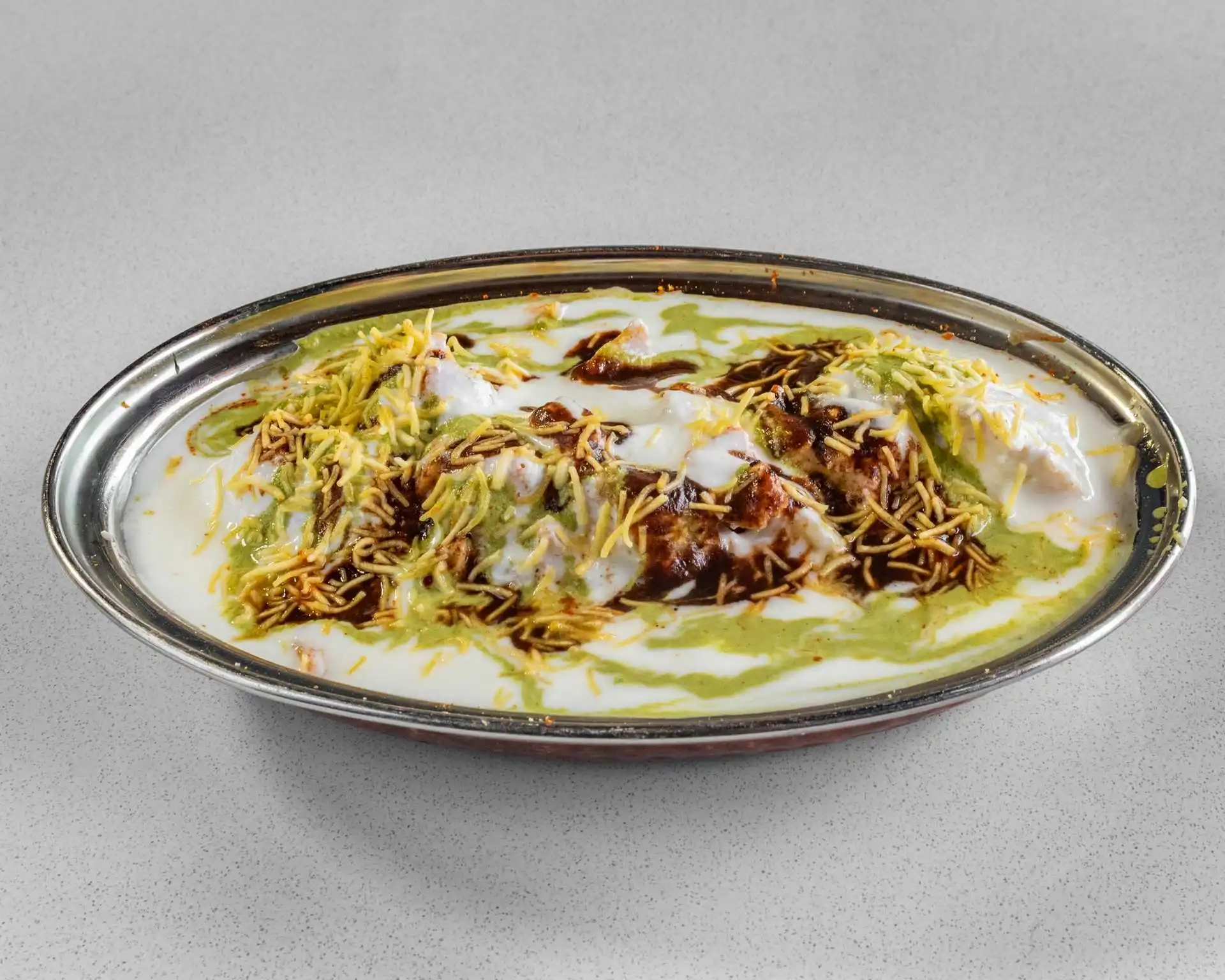 Chilled yogurt appetizer with chutneys and crispy toppings at Dak Land Restaurant in Warman